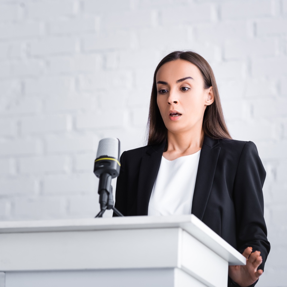 scared lecturer suffering from fear of public speaking while standing on podium tribune