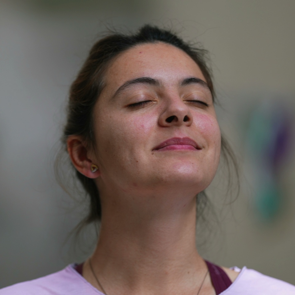 Meditative woman eyes closed taking a deep breath out contemplative person
