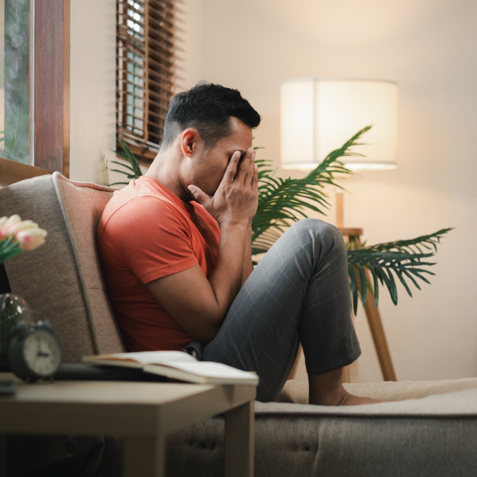 Feeling stressed in the house on the sofa, There is depression due to stress problems in the living room, Become sensitive due to chronic problems at work.