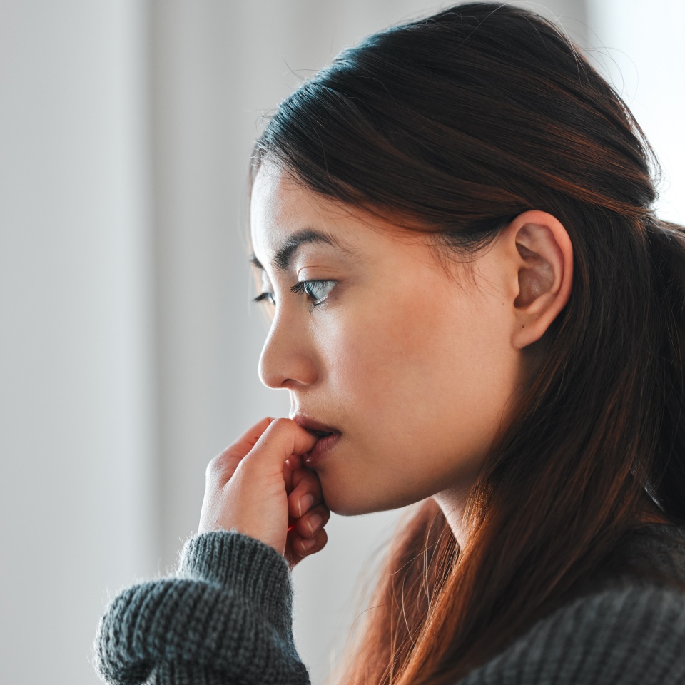 Mental health, woman and nervous of stress in home with failure, paranoid or regret trauma. Overthinking, person and anxiety in house for ptsd, isolation or victim phobia with thinking or nail biting.